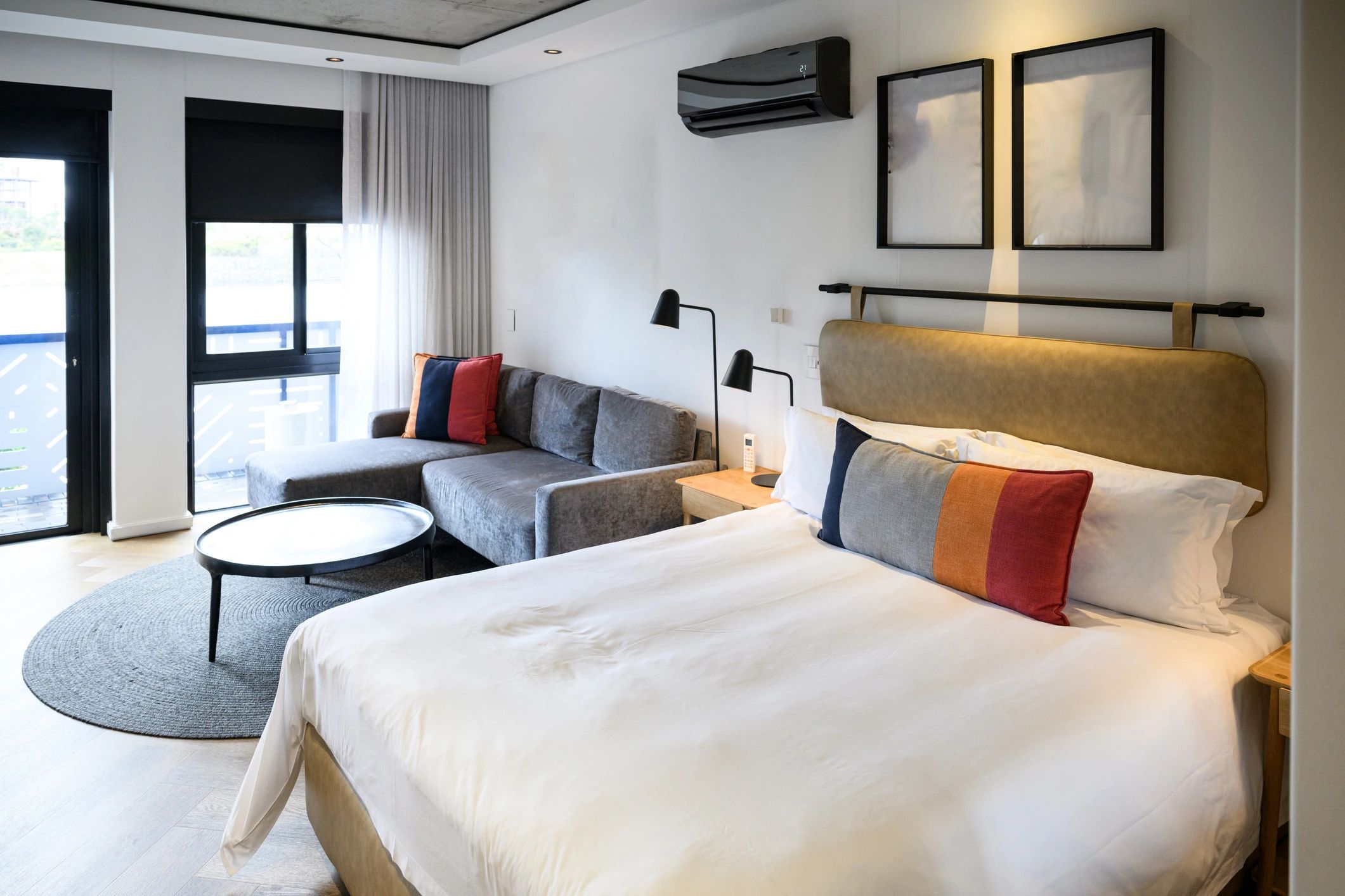 Modern, clean motel room interior with a king bed